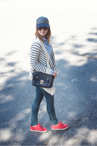 Caroline Knapp of HOUSE of HARPER looks casual chic in her airport style with a stripe cardigan and baseball cap.