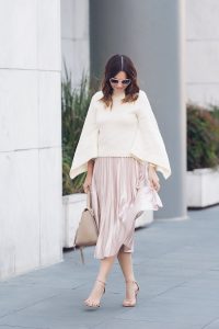 Caroline styles a pink velvet pleated skirt