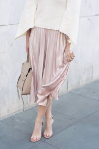 Caroline styles a pink velvet pleated skirt